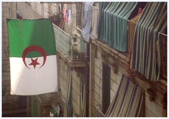 Downtown Algiers with huge Algerian flag