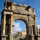Monumental arch in Djemila set against a blue African sky